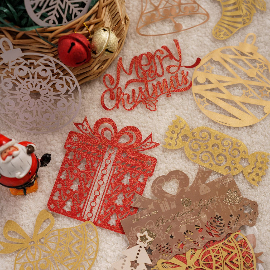 Red and gold laser cut Christmas gift lace paper pieces on black
