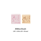 Ribbon Beads beech wood stamp – laser engraved ribbon and bead design, 1.96 × 1.96 in (50 × 50 mm), in gift box