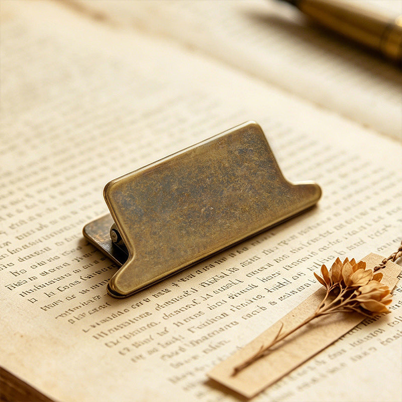 Side angle of walnut panel journal clip showing zinc alloy antique bronze body