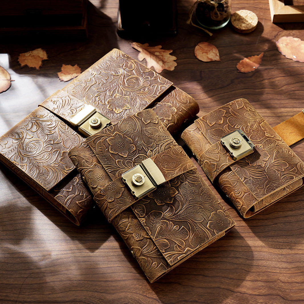 Two carved leather lock journals A6 stacked on rustic wood