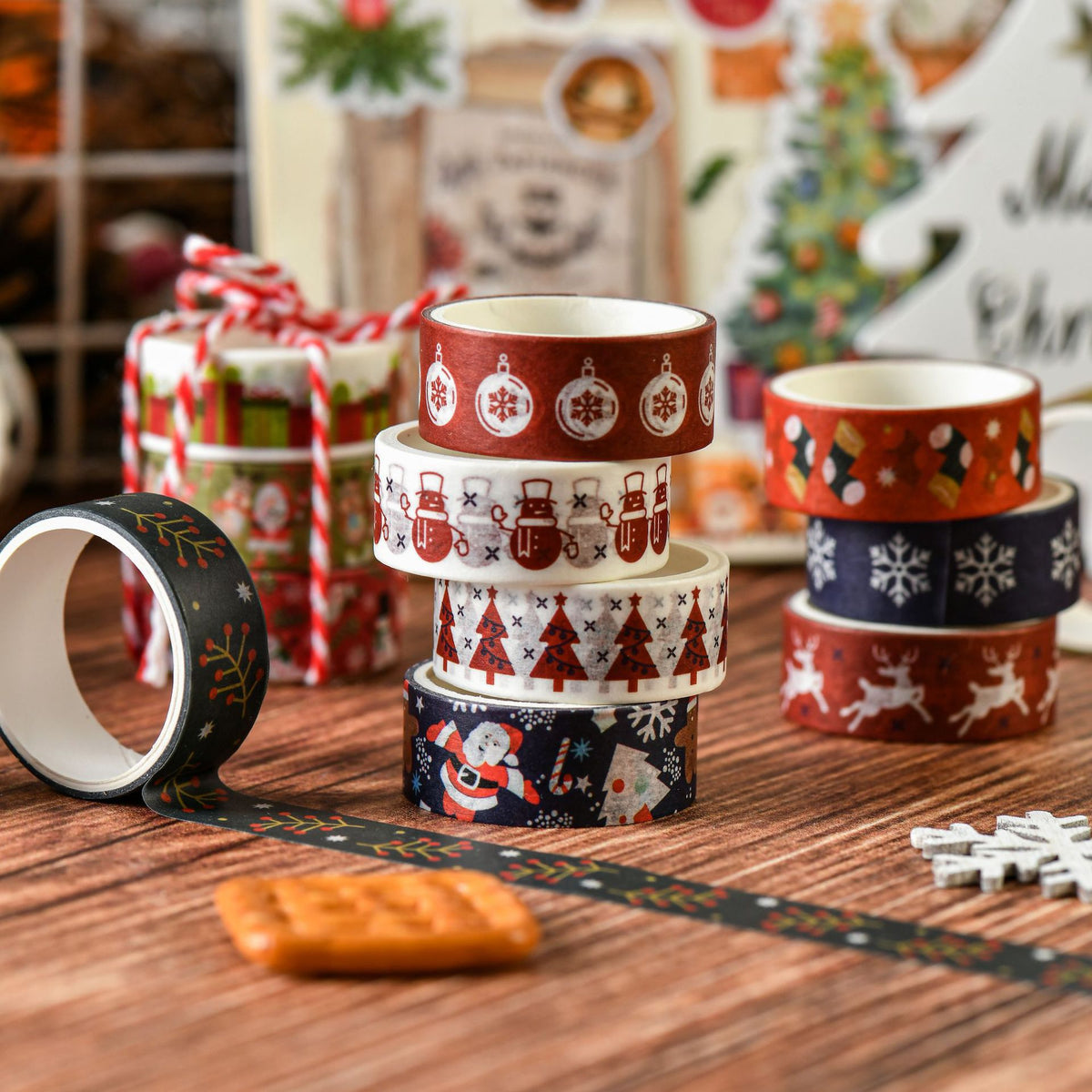 Stacked Christmas washi tape rolls with decorative strips and ornaments