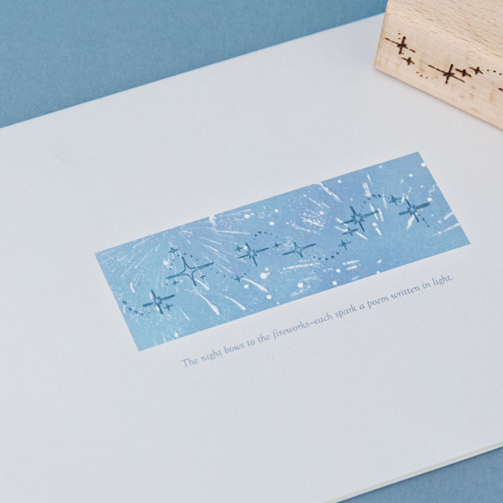 Star trail transparent impression on blue background with scattered stardust and celestial border design, carved rubber constellation stamp print for scrapbook layering