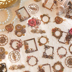 Vintage steampunk PET stickers with brass gears, clock faces, rose frames, and heart locks scattered on white lace fabric.