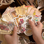 Hands fanning out vintage museum-themed stickers