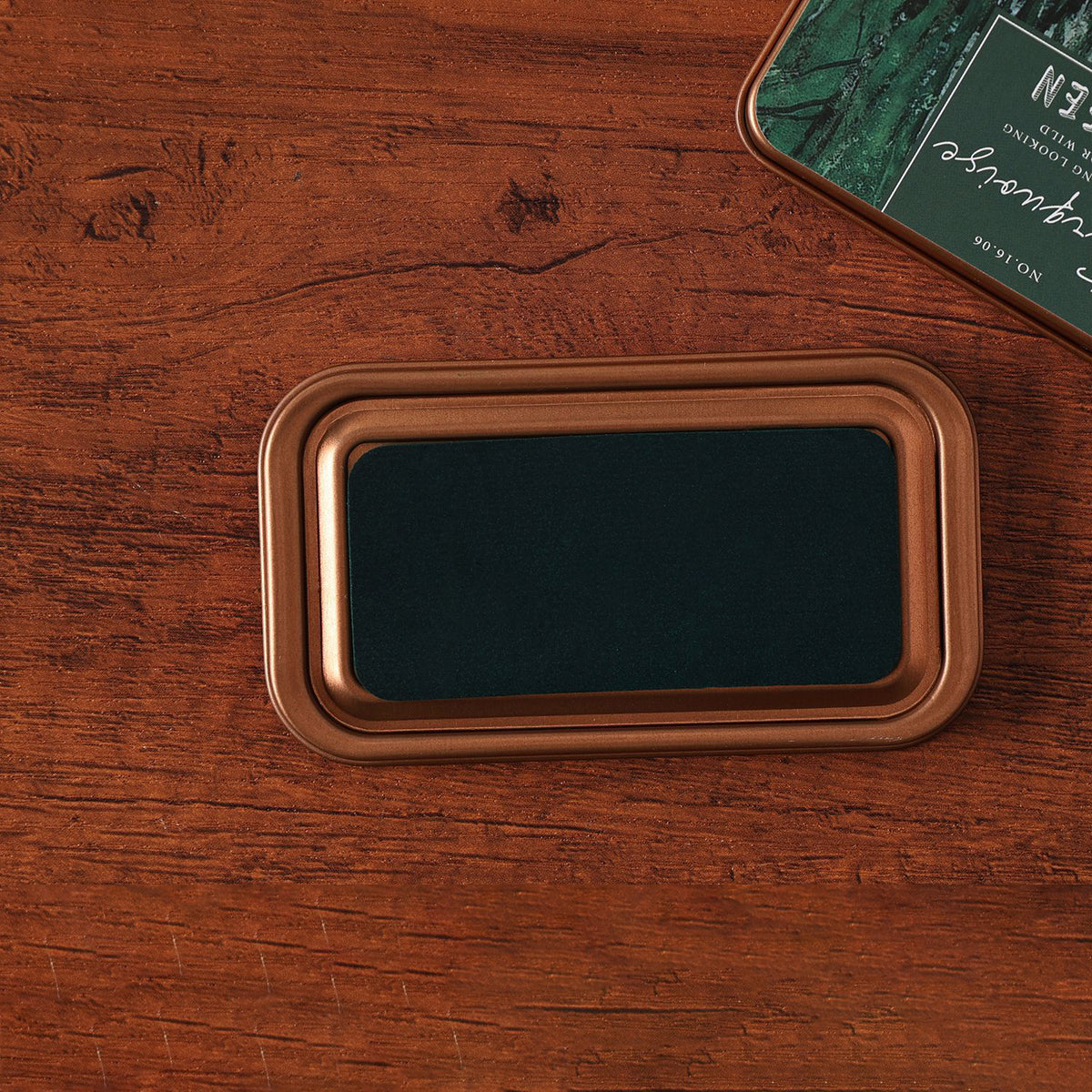 Vintage iron box ink pad in Turquoise open on wood, green stone lid beside