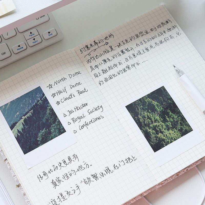 Open tweed journal spread with grid pages, photos, and handwritten notes