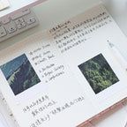 Open tweed journal spread with grid pages, photos, and handwritten notes