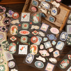 Close-up of vintage cat stickers with botanical floral patterns