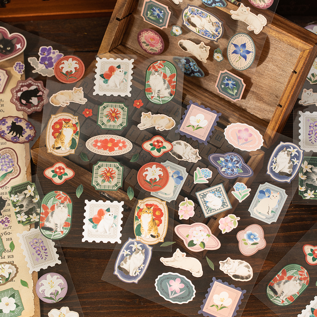 Close-up of vintage cat stickers with botanical floral patterns