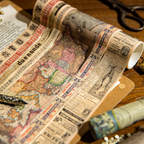Close-up of vintage alphabet and map washi tape rolls