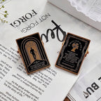 Gold embossed binder clips on open book pages