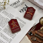 Red embossed magic binder clips with fountain pen on desk