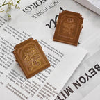 Black arched embossed binder clips holding book pages