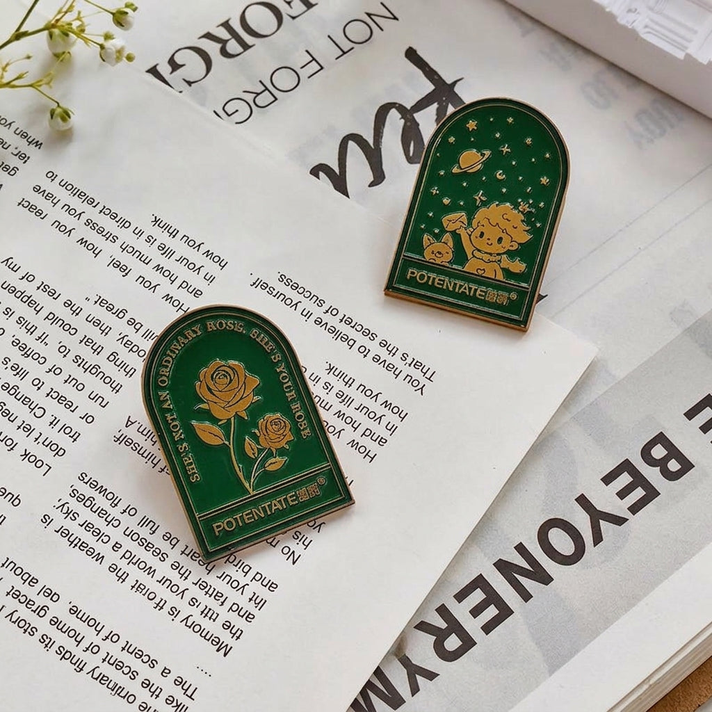 Green embossed rose binder clips on vintage book pages
