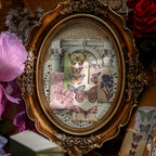 Vintage butterfly ephemera cards arranged in ornate frame with pink rose and iris prints on lightweight paper for dark academia journal decoration
