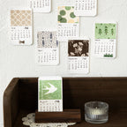 Vintage calendar themed ephemera paper sheets with month names and date grids printed, mixed lightweight paper and PET overlays for planner decoration and collage
