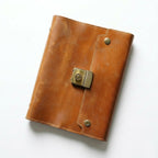 Vintage Cognac rustic leather travel journal with a secure 3-digit lock and aesthetic compass embossing for explorers and adventurers.