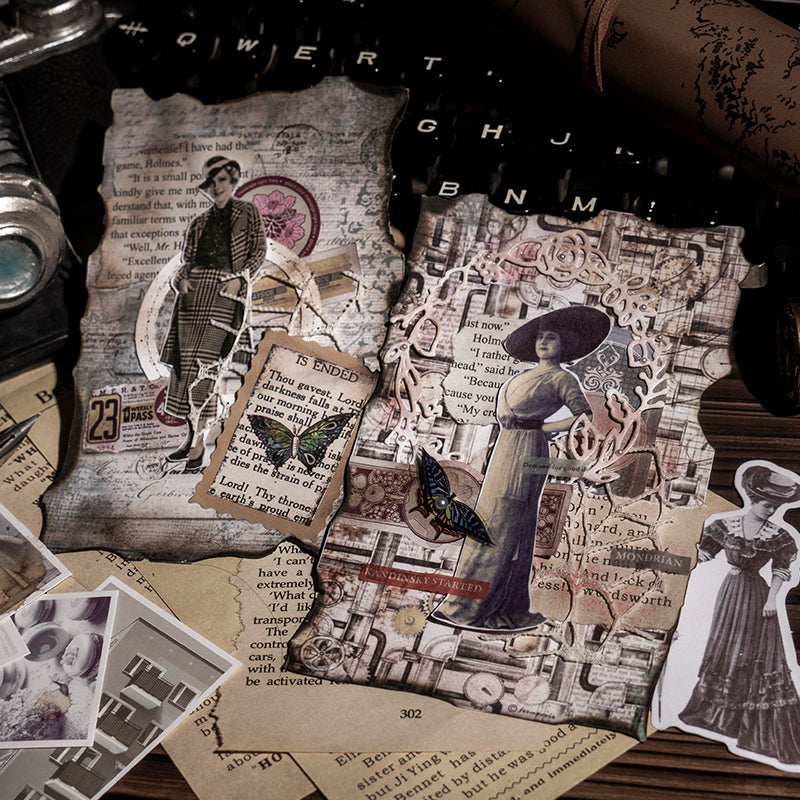 Two vintage collage cards placed on a black typewriter, layered with character stickers, butterfly cutouts, and delicate lace borders over aged manuscript paper.