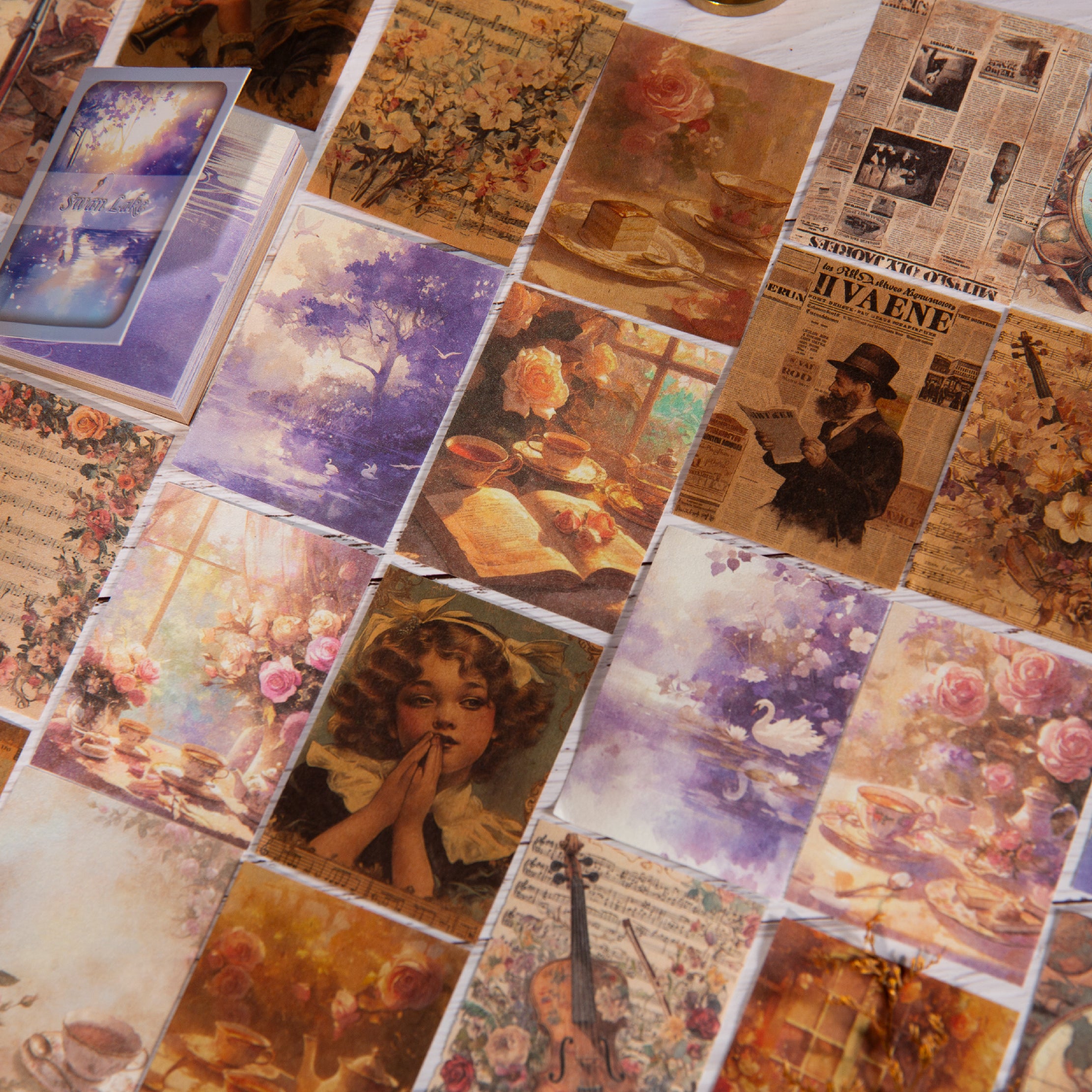 Flat lay of assorted vintage ephemera cards featuring botanical, maritime, and newspaper designs in warm tones.