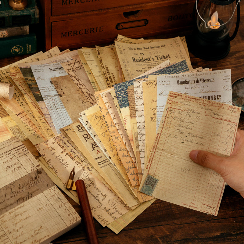 Fanned vintage ephemera paper sheets with aged tickets, handwritten letters, and ledger pages over a wooden desk with brass pen.