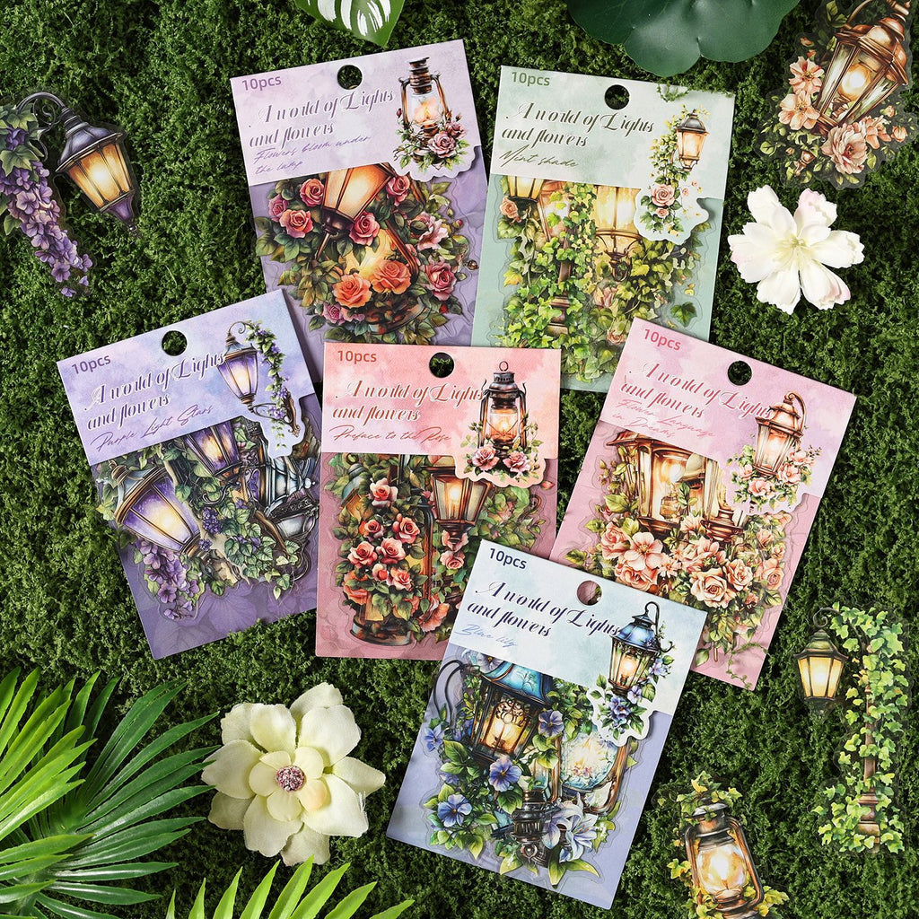 Six lantern sticker packs arranged on green grass with flowers