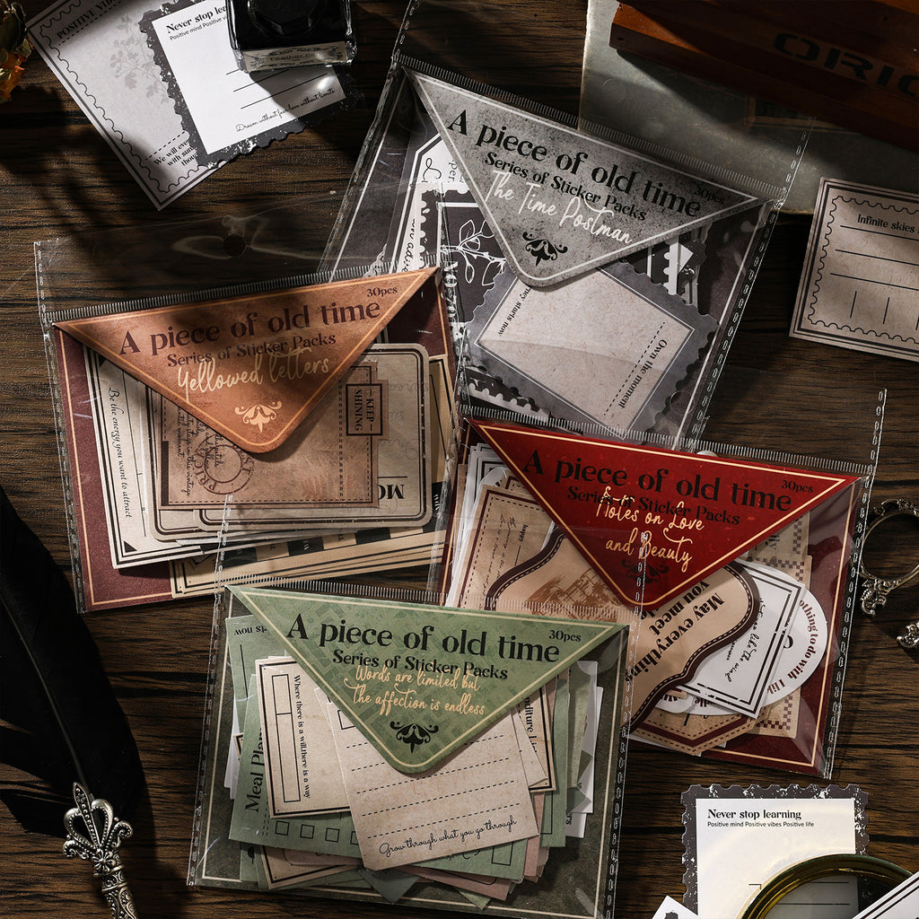 Four vintage letter sticker packs spread on dark wood desk — Yellowed Letters, The Time Postman, Notes on Love and Beauty, and Words Are Limited themes