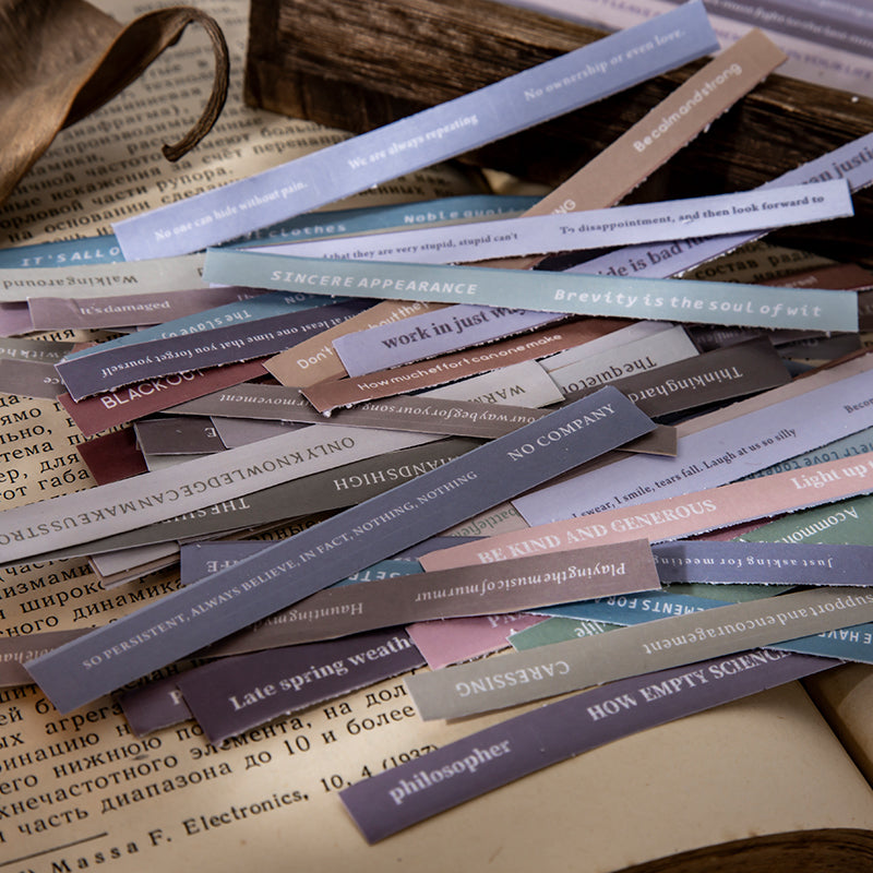 Close-up of vintage library stickers showing literary text and book-themed designs for bullet journaling