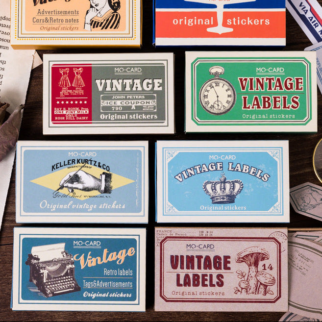 Vintage matchbox label stickers set — multiple themes displayed in tin-style matchbox cartons