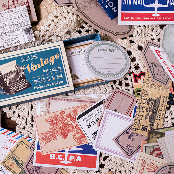 Vintage label stickers spread flat showing airmail, botanical and ticket designs on kraft paper background