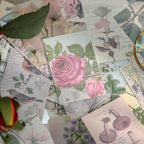 Scattered vintage mini ephemera cards with lightweight paper showing pink rose, bird illustration, and botanical prints for scrapbook collage and journal layering
