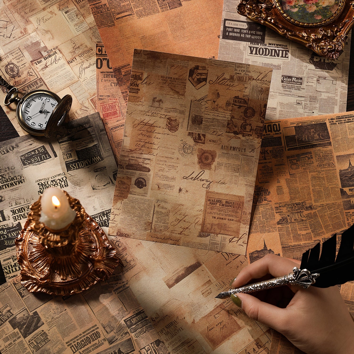 Distressed vintage newspaper print art paper sheets from the collage kit, styled with a lit candle, antique pocket watch and feather quill pen