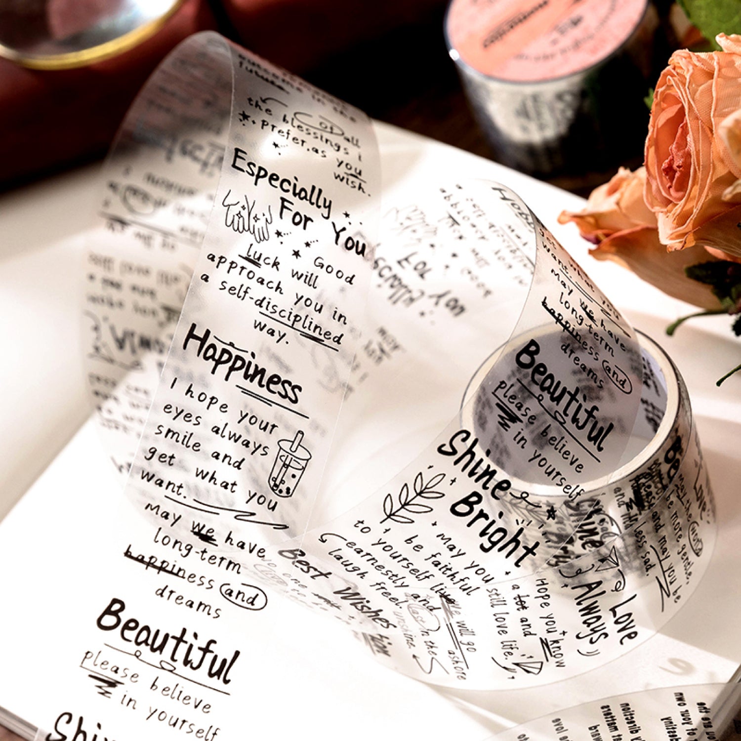 Close-up of vintage script PET tape rolls showing printed labels like Psalm Fragments and Happy memories on translucent backing.