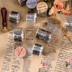 Vintage script PET tape rolls and unrolled strips featuring English text, postage stamps, and butterfly motifs on paper.