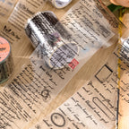 Unrolled vintage script PET tape strips with handwritten English paragraphs and decorative text laid flat for display.