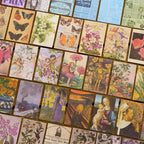 Flat lay of vintage ephemera paper sheets showing butterflies, flower fairies, Renaissance paintings, botanical prints and newspaper backgrounds spread on wood surface
