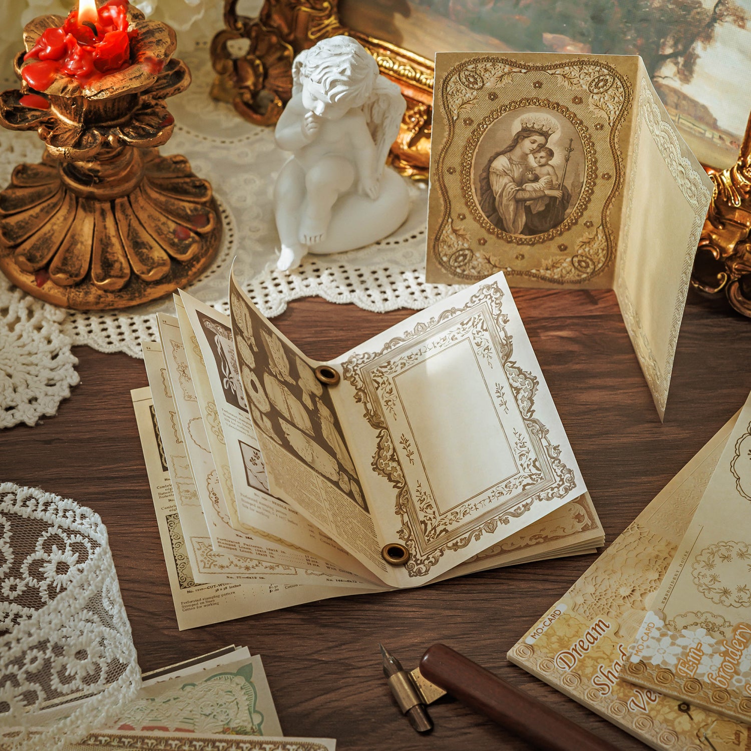 Vintage lace memo pad booklet opened for handwriting with a wooden fountain pen and candlelight

