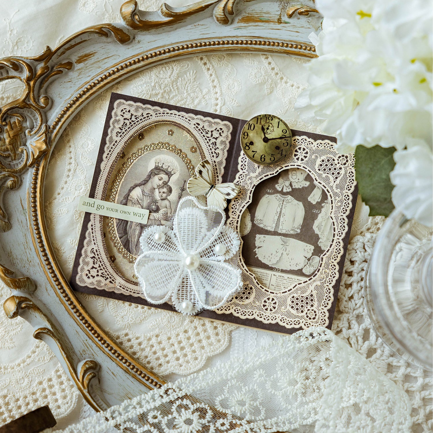 Vintage lace memo pad used in a romantic journal spread with pearls, butterflies, and a brass clock