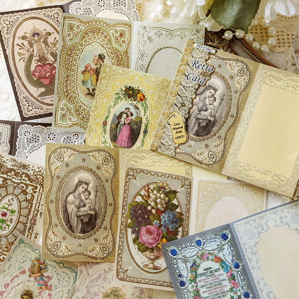 Vintage lace memo pads with religious portraits and floral borders scattered for bullet journaling