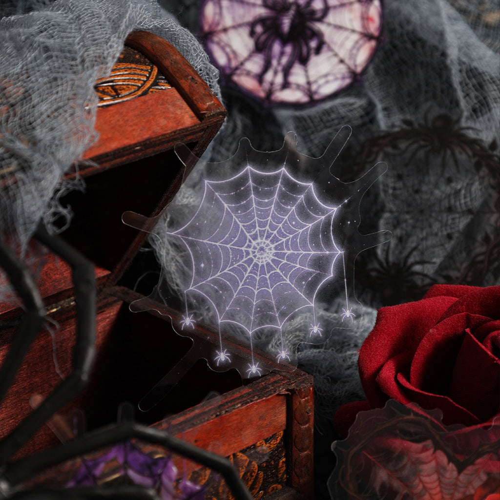 Purple spider web sticker styled with a moth on dark red silk