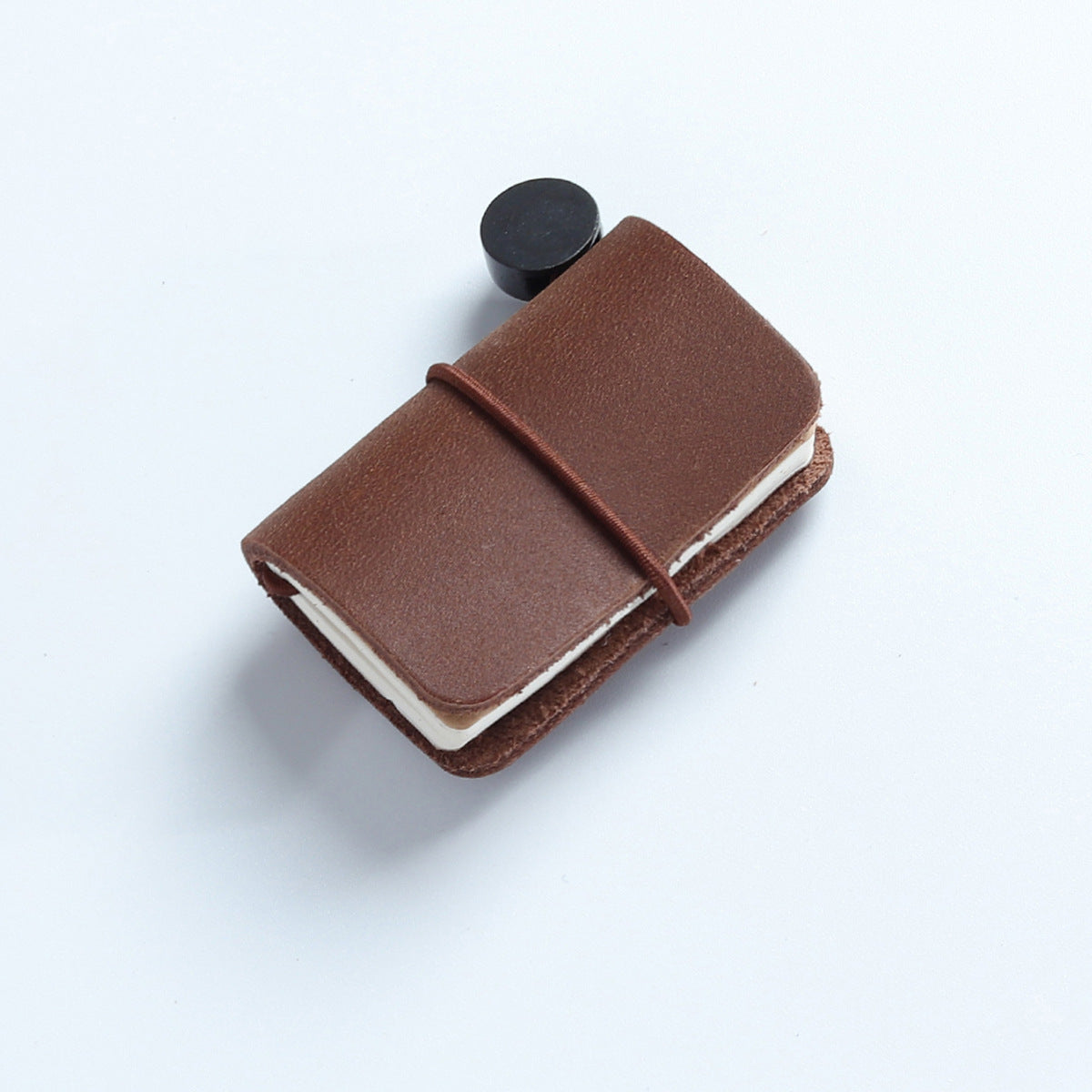 Tan waxed leather mini traveler's notebook charm with elastic band and vintage metal clasp