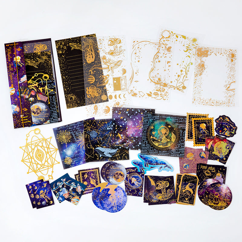 Dark purple celestial whale sticker set flat lay with galaxy planets and gold foil stars for space theme journaling