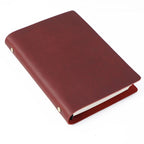 Wine red crazy horse leather A5 notebook with brass ring binder and aged leather finish.