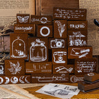 Vintage wooden stamps displayed on a shelf with journaling props 