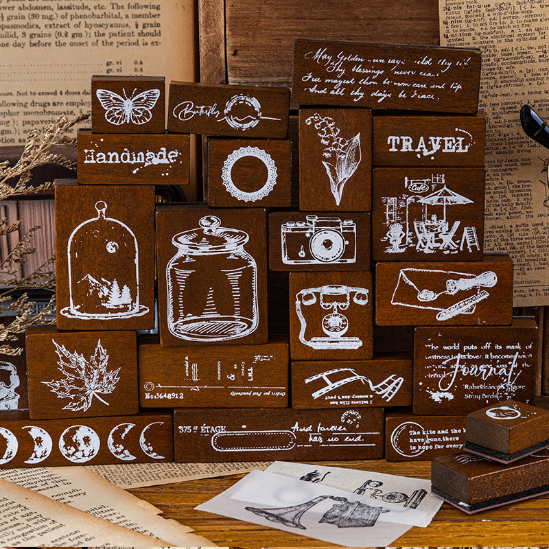 Vintage wooden stamps displayed on a shelf with journaling props 