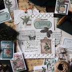 Woodland Walk vintage washi sticker book with green forest-themed illustrations displayed on botanical paper with fern and pressed flower accents