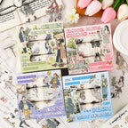 Overhead shot of all four styles of the Radiance Gentle Words washi tape collection: Meadow Whispers (Green), Sunny Campus (Purple), Spring Picnic (Pink), and Cozy Café (Blue). Each set contains 6 rolls.