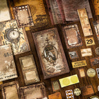 Close-up of the vintage hardcover journal surrounded by a massive assortment of scrapbook ephemera. Highlights the detailed aesthetic tickets, translucent vellum papers, kraft frames, and vintage postmarks perfect for crafting.