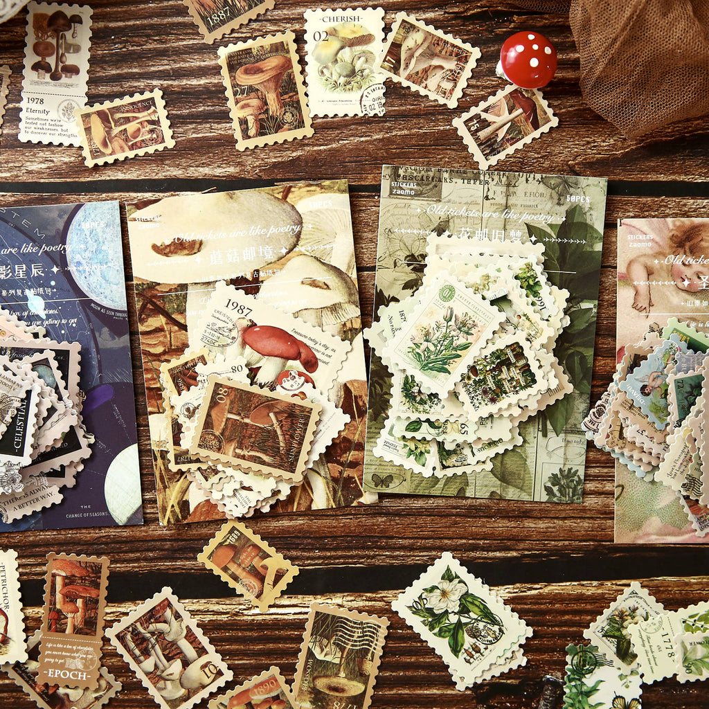 Starry night postage stamp stickers spread on rustic wood – moon phases and constellation designs with postmark details