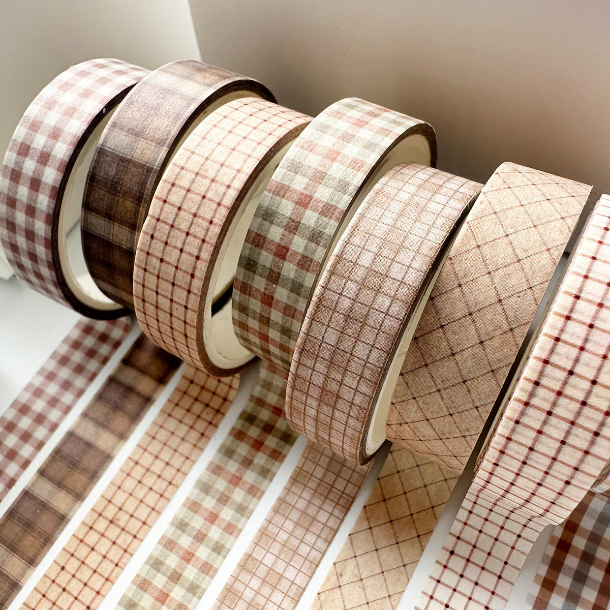 Detailed view of the Classic Tartan slim washi tape set, showcasing unrolled strips of vintage brown and beige plaid and grid patterns, perfect for minimalist scrapbook borders.