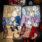 Overhead view of all six styles of the Premium Mixed Media Junk Journal Kit collection, including Midnight Rose, Celestial Ocean, and Clockwork Bronze. Each pack displays its unique color palette, 3D flowers, and holographic elements.